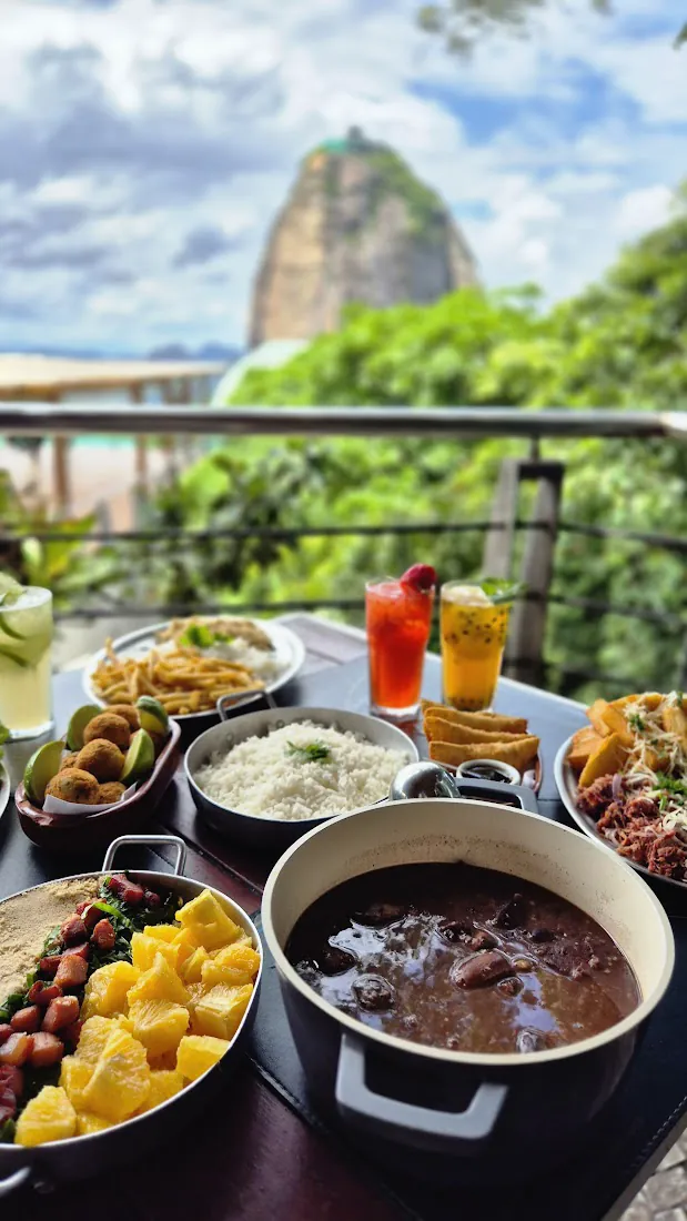 Mesa com feijoada e o Pão de Açúcar ao fundo