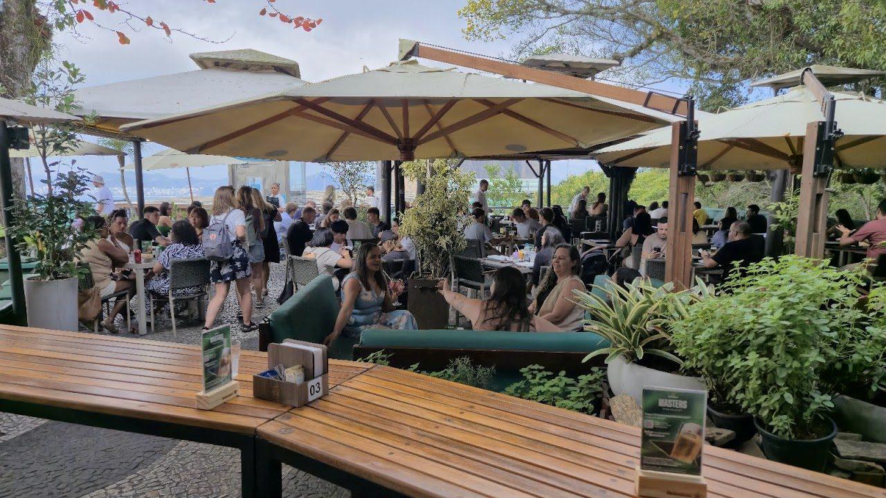 Visitantes nas mesas cobertas do terraço